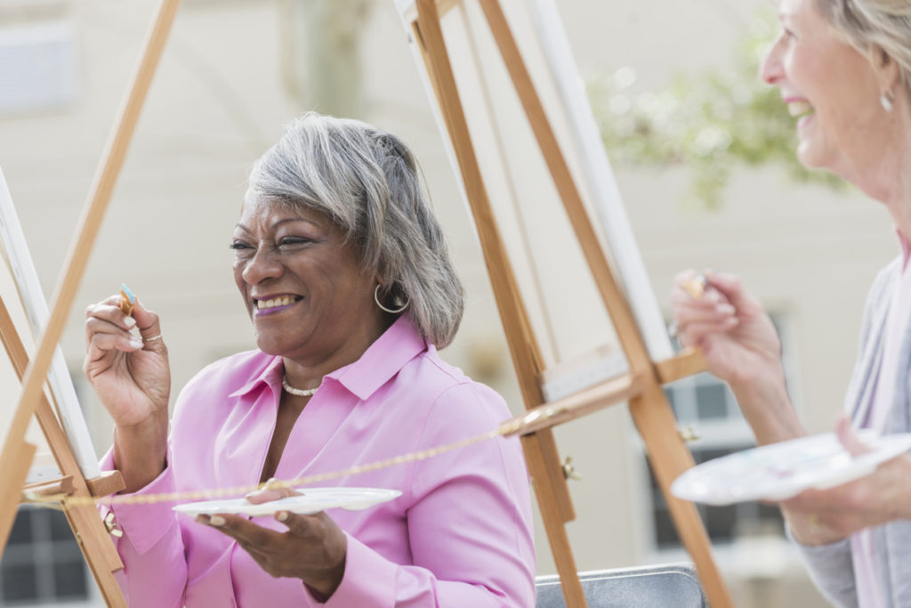 Senior women painting on a canvas